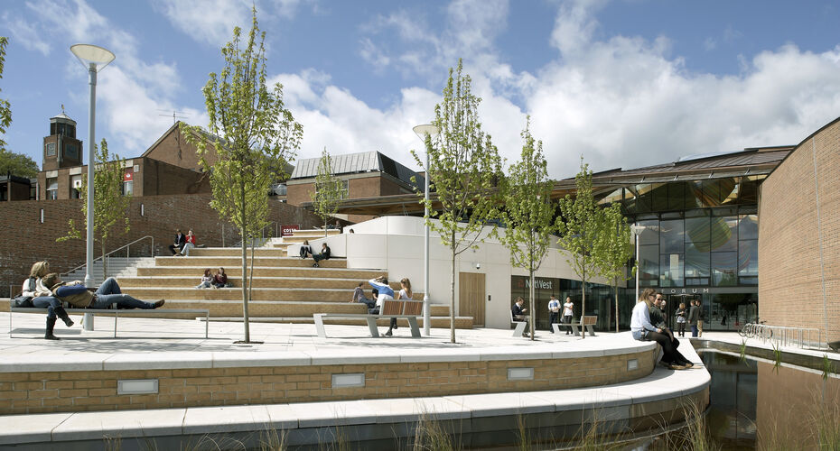 Students sitting on a piazza on campus on a sunny day
