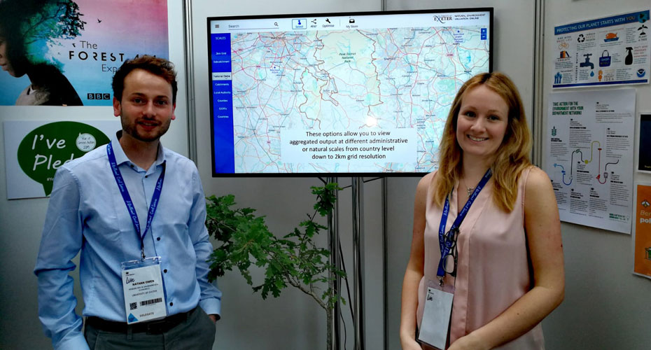 Nathen Own and Amy Binner standing in front of a screen showing a map.