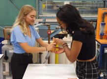 iGEM team members Rachael Quintin Baxendale left and Lydia Pike fitting the filter to a washing machine waste pipe