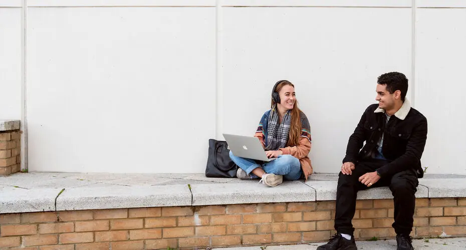 Students sitting on wall