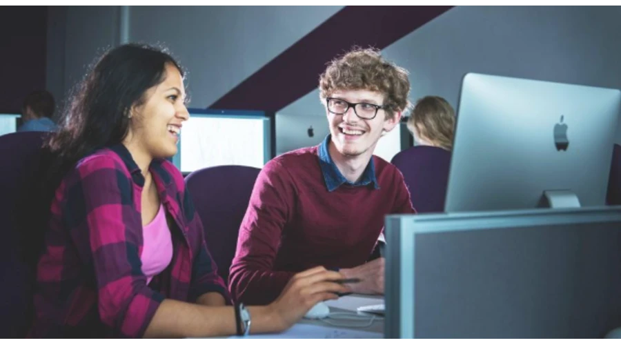 image of two students sat in front of a computer