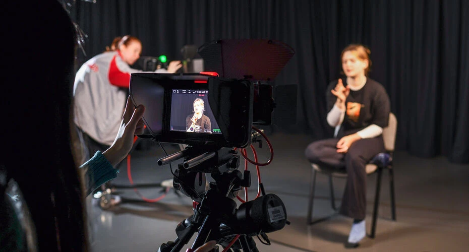Photograph of drama students operating an industry standard Blackmagic equipment.