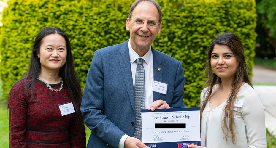 Iqraa, the first recipient of SSIS PTA Studentship, being presented with their certificate of scholarship.