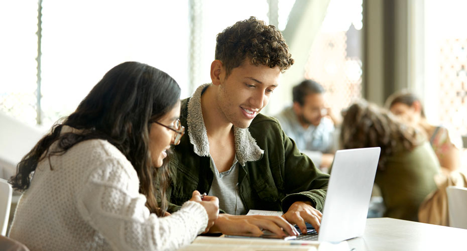 Students with their laptops in a study space