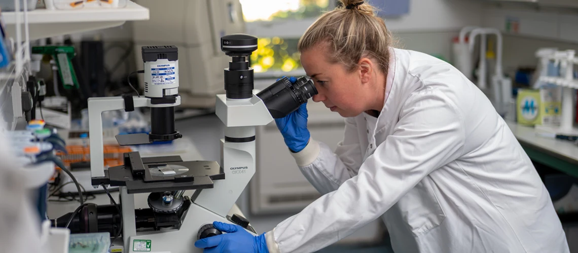 A Biomedical Sciences student working in a lab on St Luke's Campus.