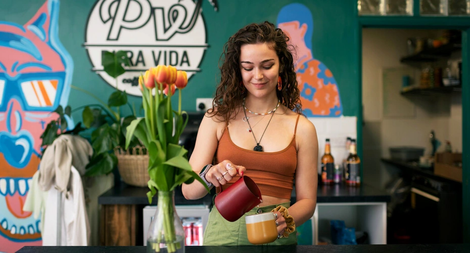 A student making a coffee in a local cafe.