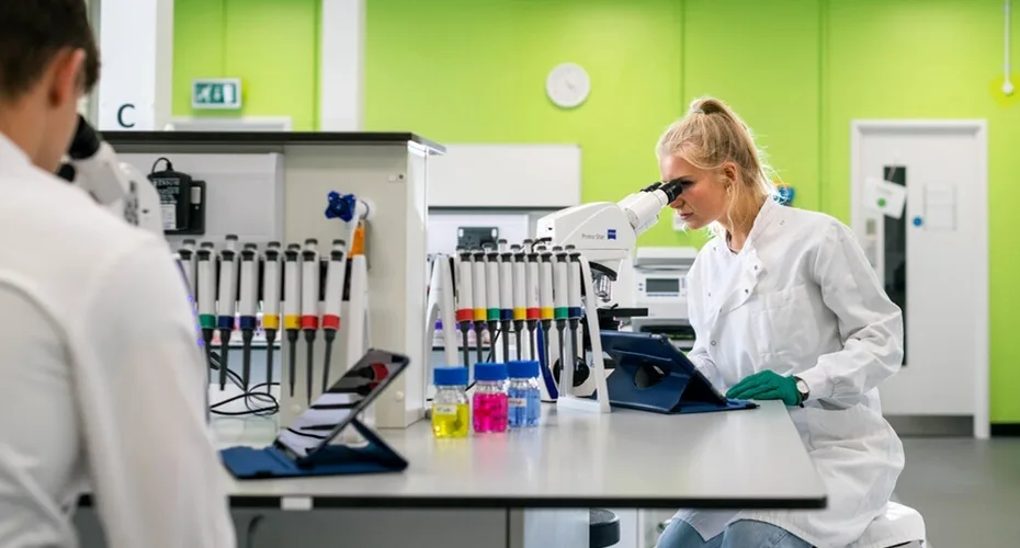 PGCE students from the University of Exeter demonstrating lab equipment.