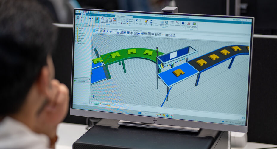 Person viewing a laptop screen with a structural engineering design on the screen.