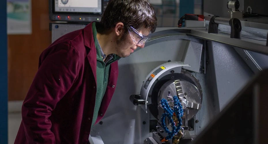 Engineering student working machinery