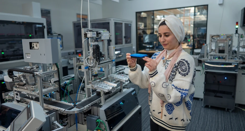 A female student in an electronic lab