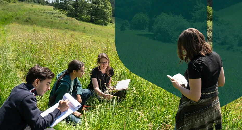 Students doing some field work in grass with clipboards and notebooks