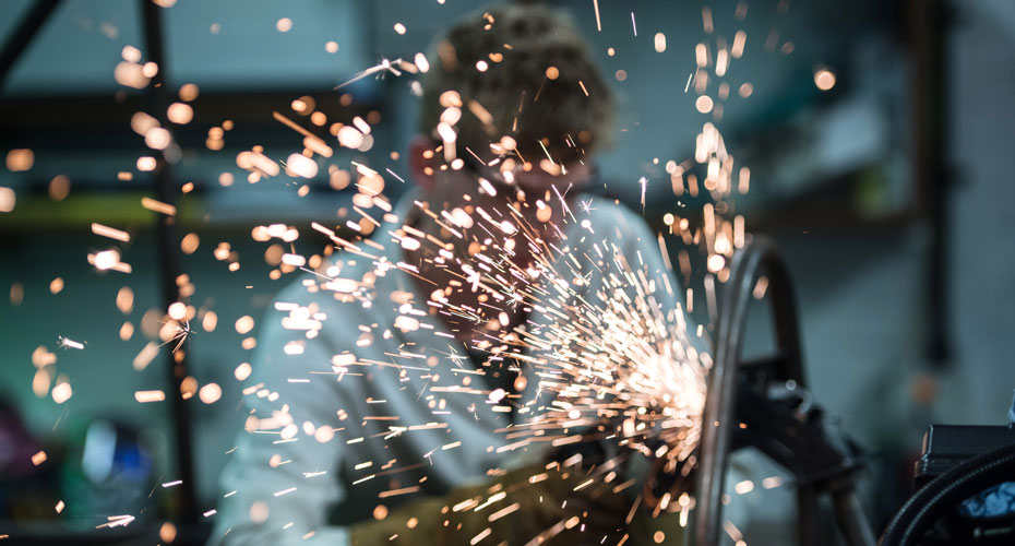 Sparks flying in front of an engineer welding