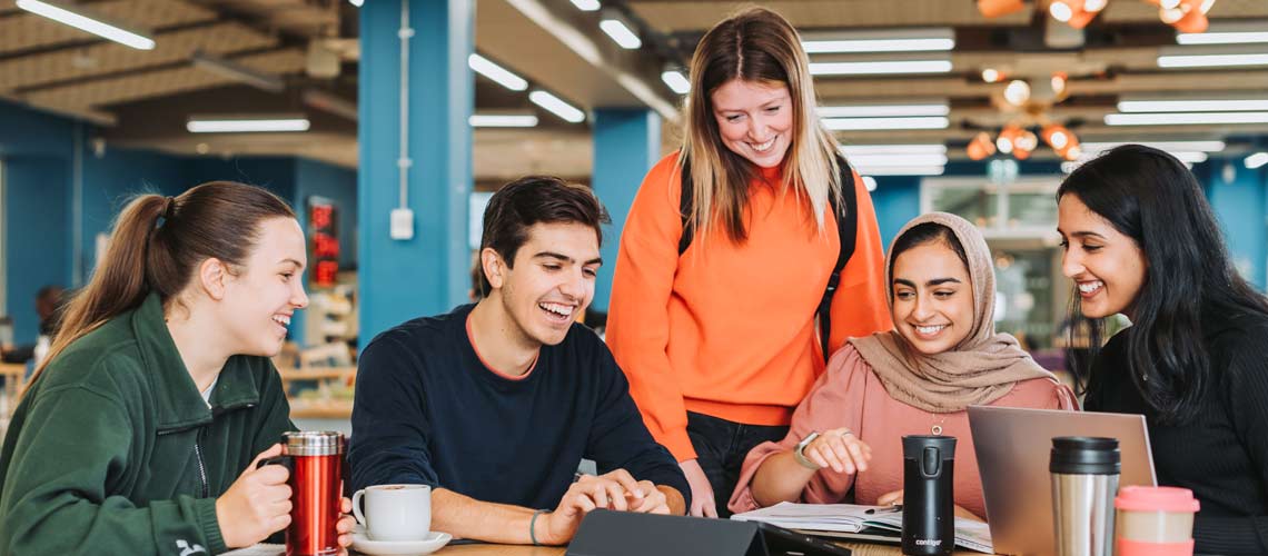 Happy students in a cafe on campus