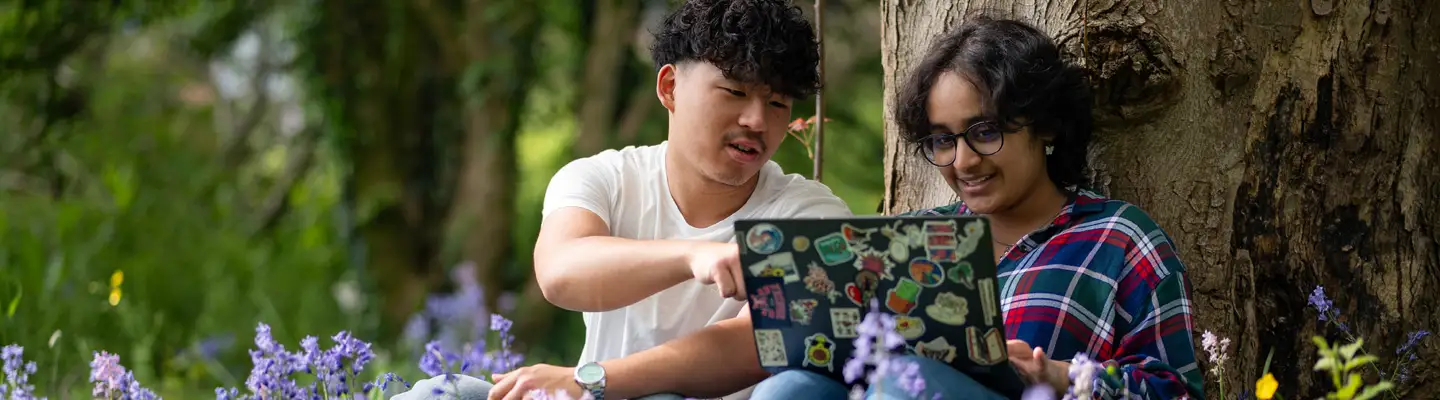 Students at winter graduation throwing their mortar boards in the air.