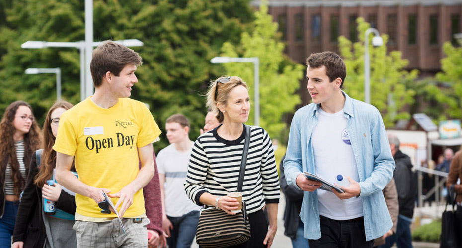 A current student talking to a prospective student and parent at an Open Day