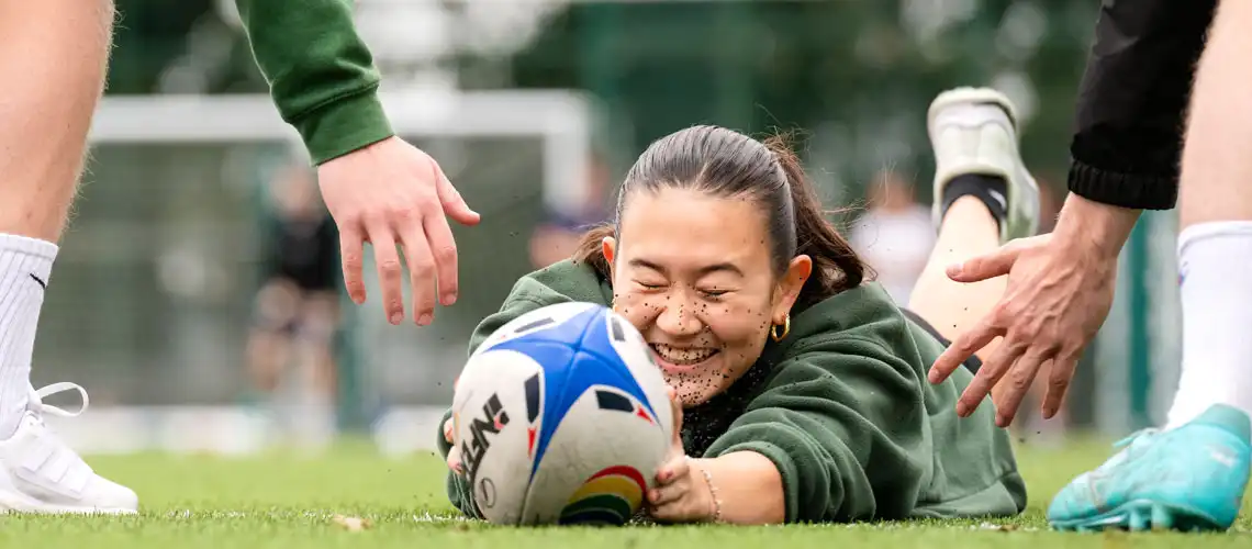 A student scoring a try at women's rugby practice