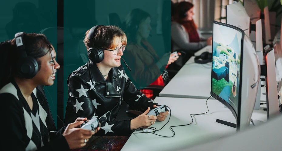 students sat on a desk in front of screens and with game controllers in hand