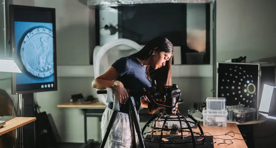 A students looking in a film camera.