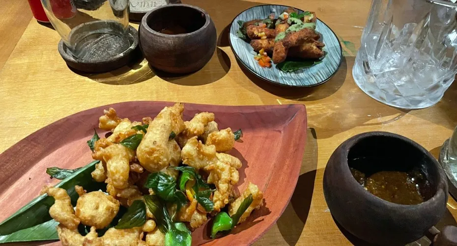 A wooden table with a plate of food, showcasing a colorful meal arranged neatly on the surface.