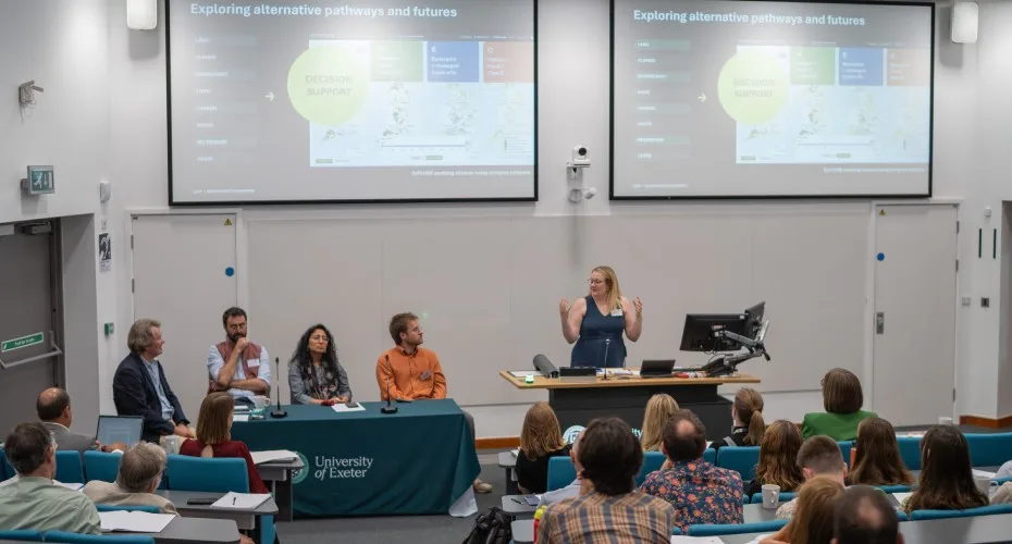 Amy Binner presents to an audience during the LEEP@10 event, engaging with attendees on stage.