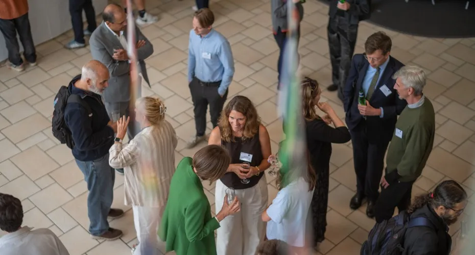 Attendees socialise in a lobby area at the LEEP@10 event, exchanging ideas and networking.