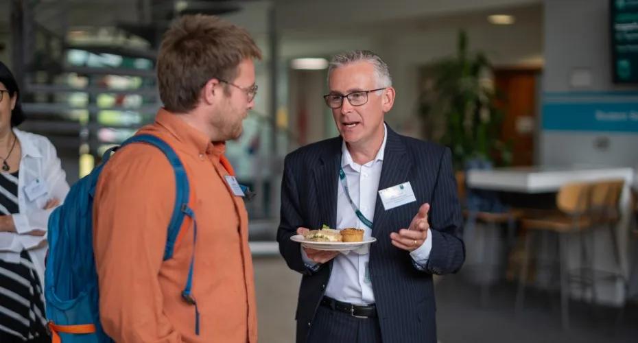 Ben Balmford and Steve Wood engaged in conversation at the LEEP@10 event in a lobby setting.