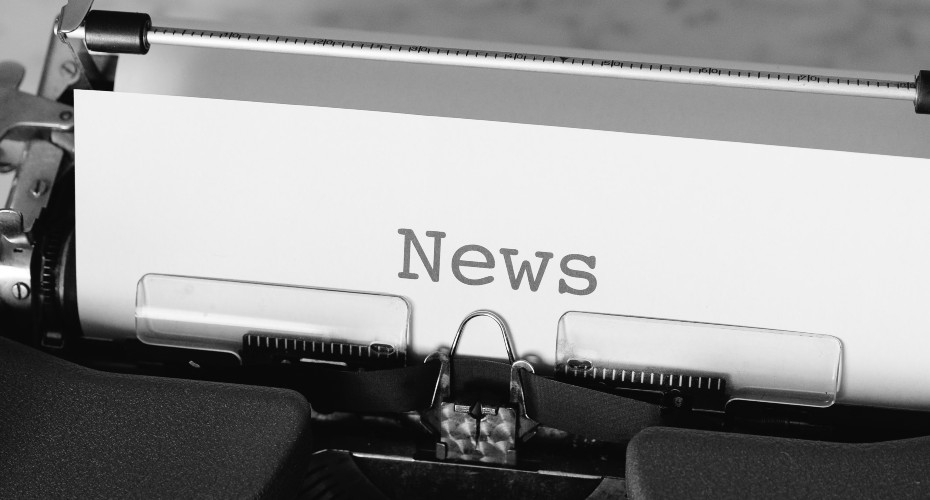 A typewriter with the the word News typed in the centre of the page