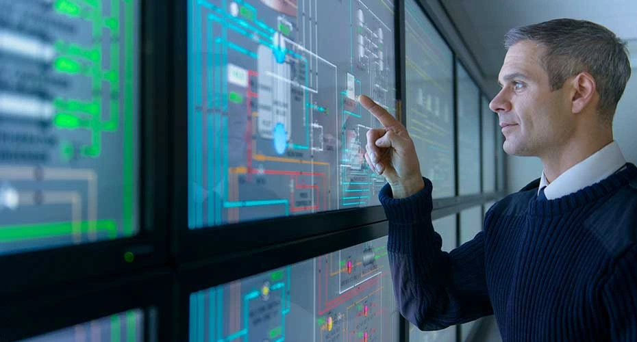 Military personnel operating equipment in ship's engine room simulator