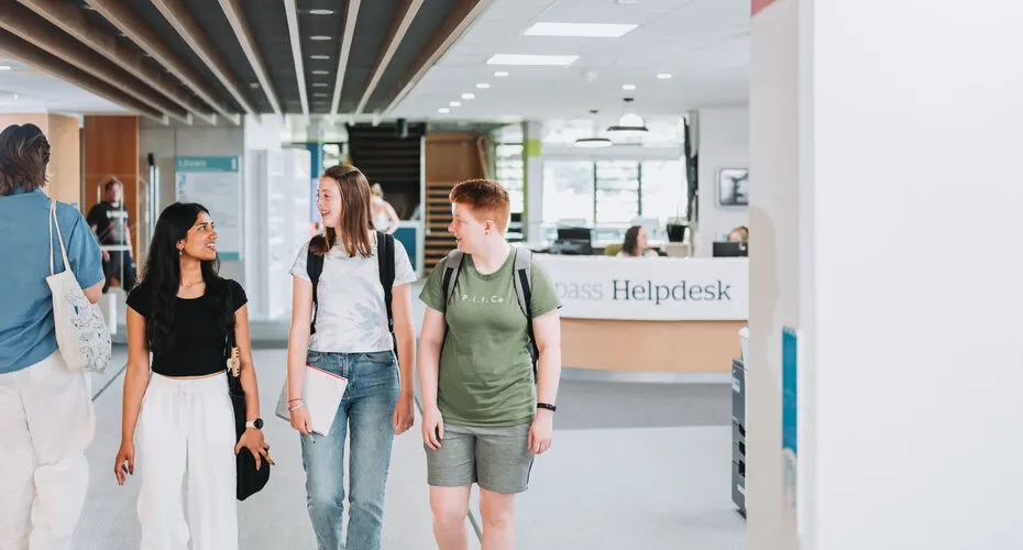 A group of Politics students chatting and walking around Penryn Campus.