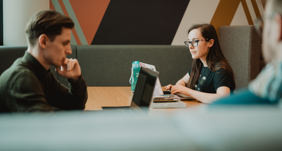 Male and Female students on laptops