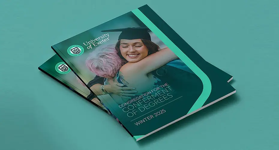 An image of the a brochure titled winter graduation 2025 on a green table top.