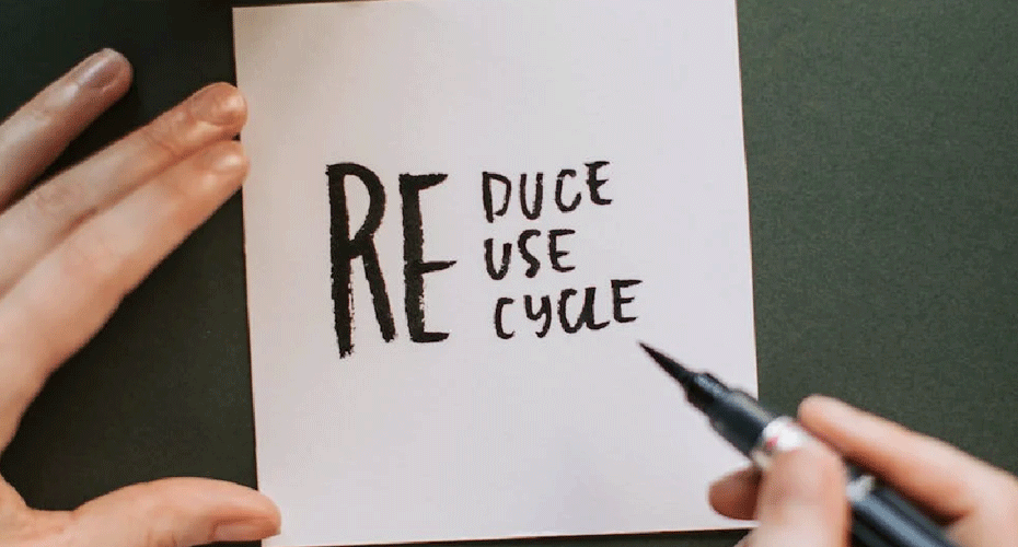 notepad with 'reduce reuse recycle' written on it