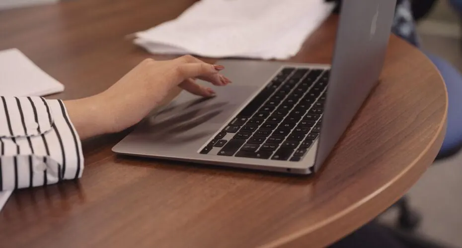 Student typing on a laptop