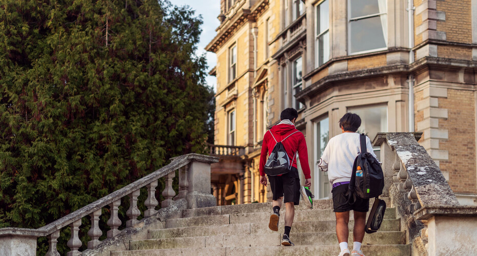 Two students climbing the steps at Reed Hall