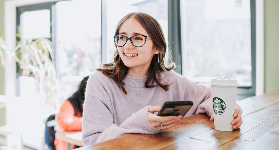 A student holding her mobile phone