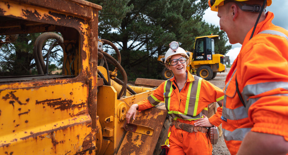 A student on a mining placement talking to a colleague