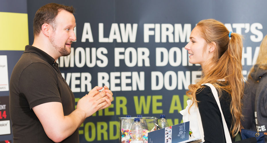 An employer talking to a student at a careers fair