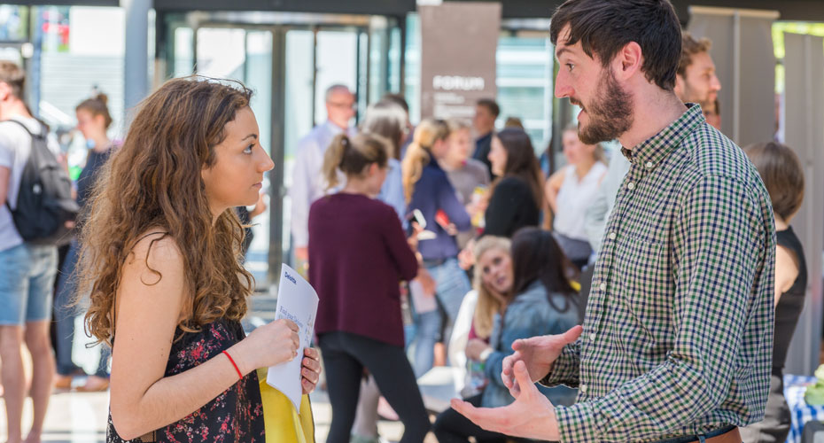 An employer talking to a student at a Careers Fair