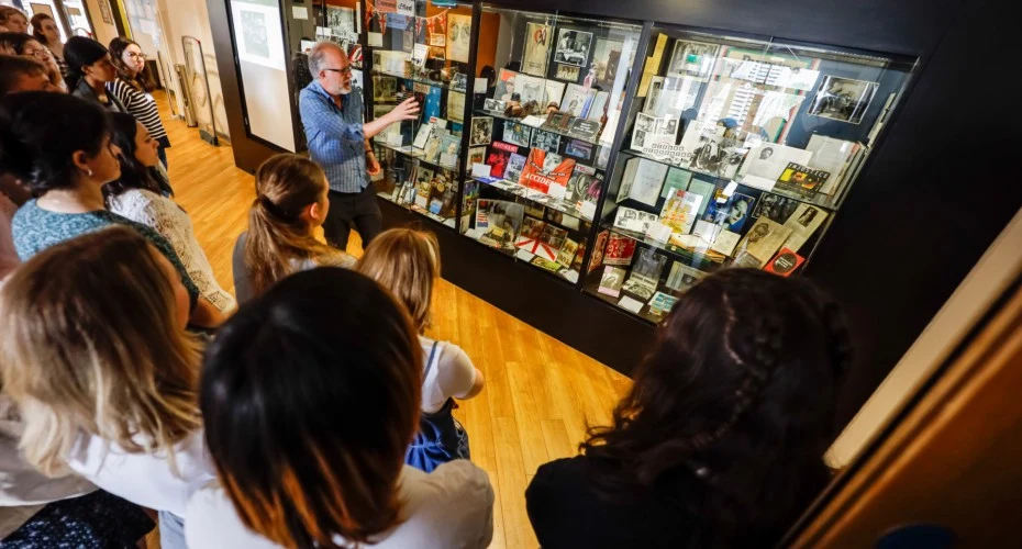 Tutor talking to a group of students at the Bill Douglas Musuem