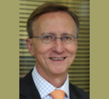 Headshot photo of David Kolitz in front of some green blinds