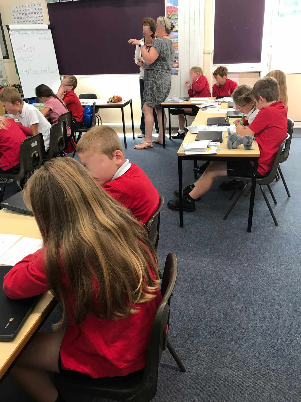 Children watching interactive scene and making notes