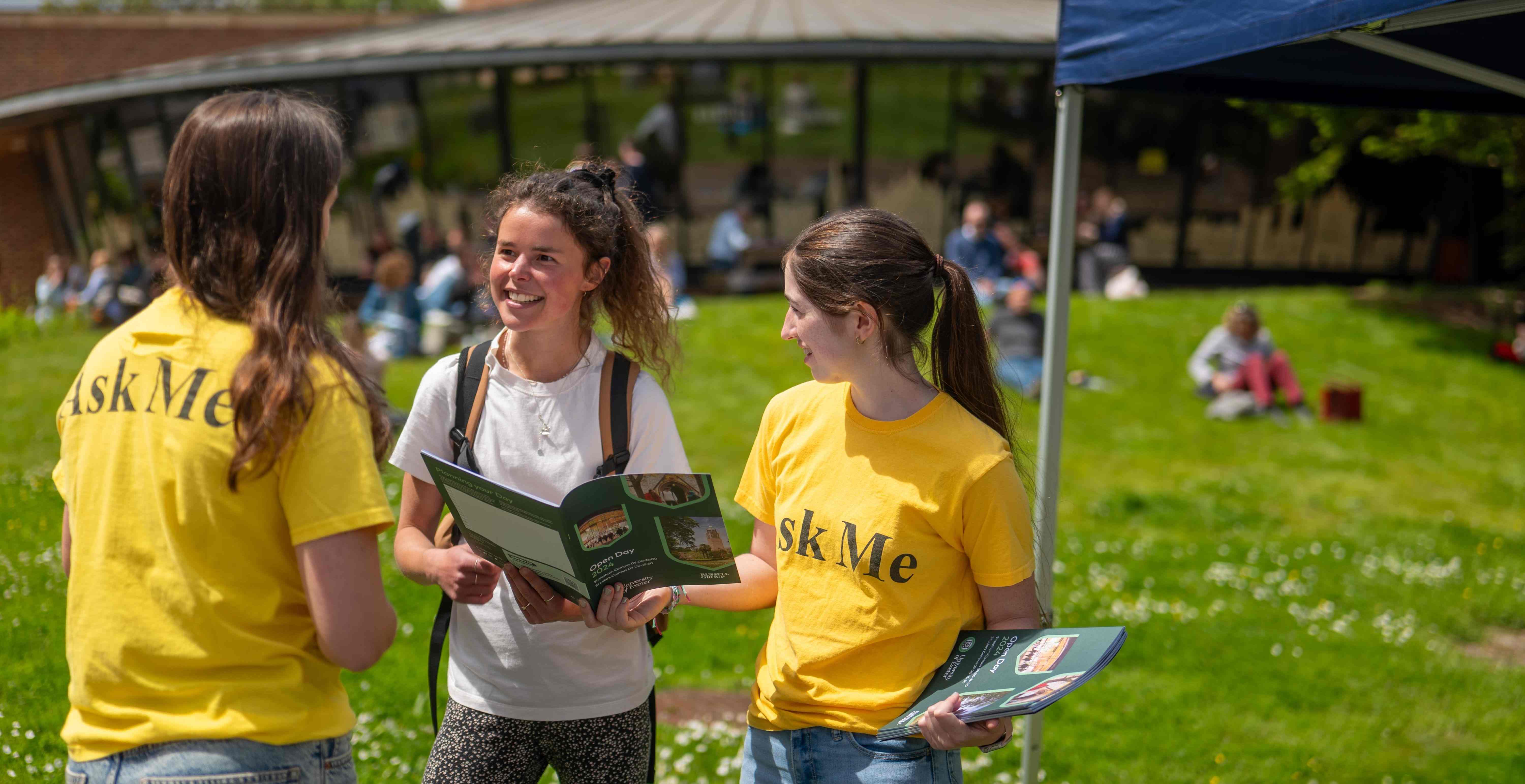 Two students talking to a prospective student at an open day on Streatham campus