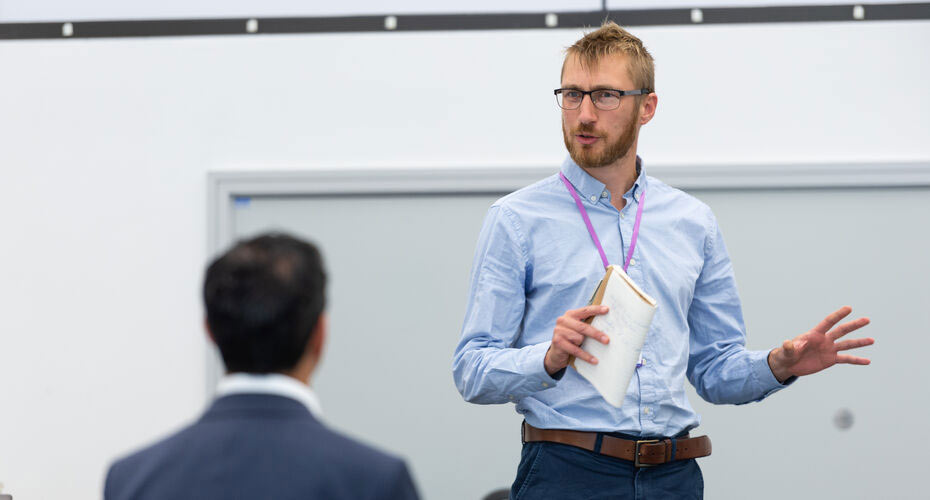 A man presenting to some colleagues