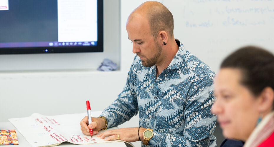 Man writing in a worshop