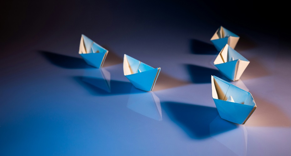 White paper boats on white surface
