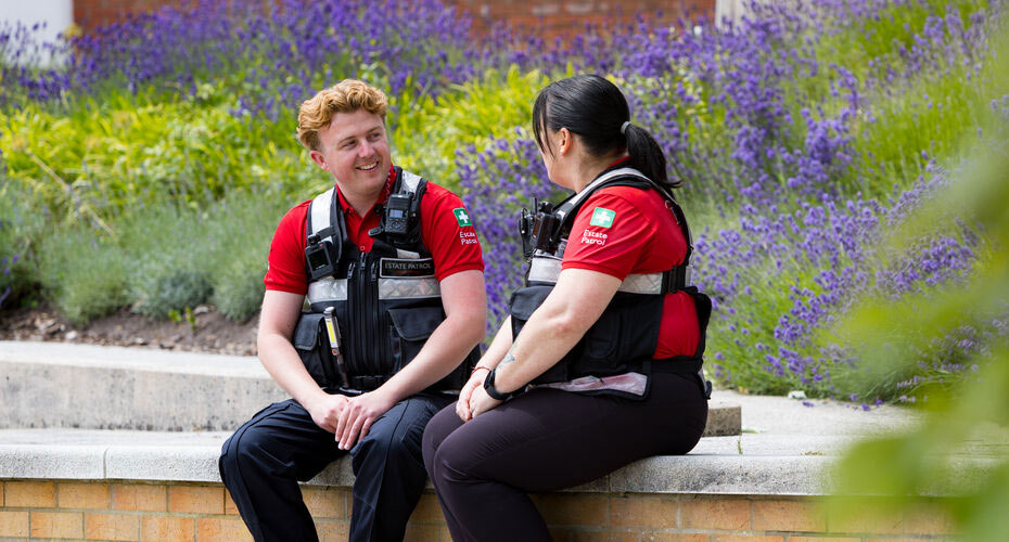 Two colleagues from Estate Patrol having a conversation on the Piazza