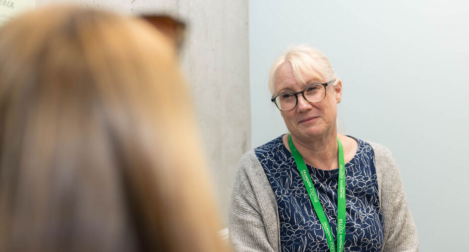 A staff member from Wellbeing Services talking to a student