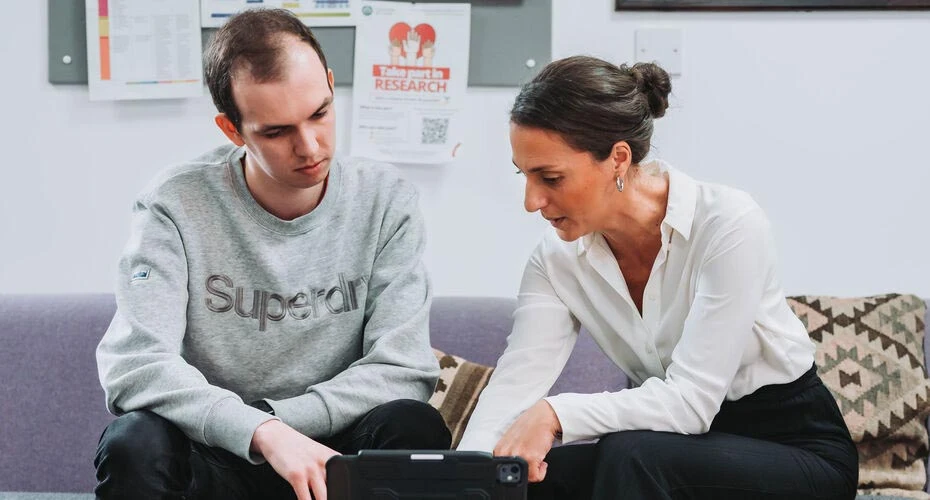 Colleagues talking and looking at a tablet