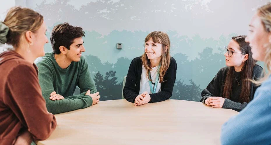 Staff members talking around a table