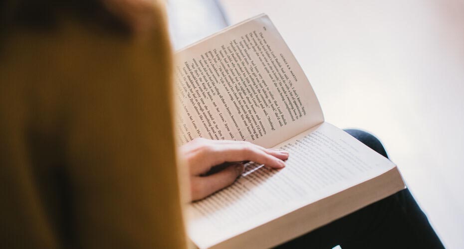Close up of person reading a book